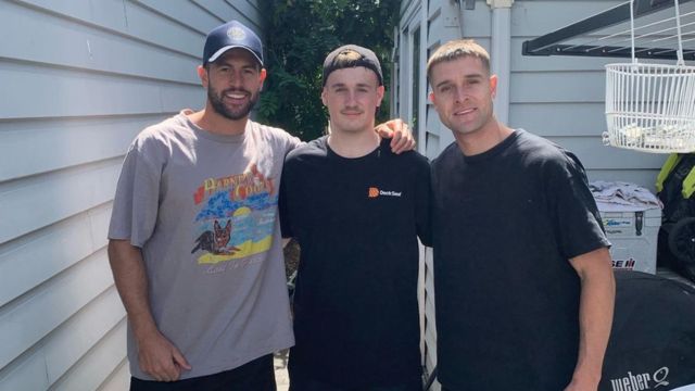 Hunter with football players from Richmond